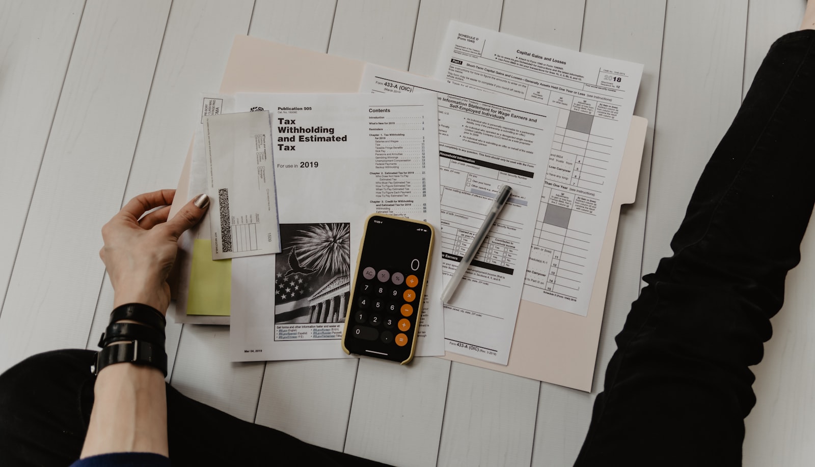 Financial charts and a phone on an office desk
